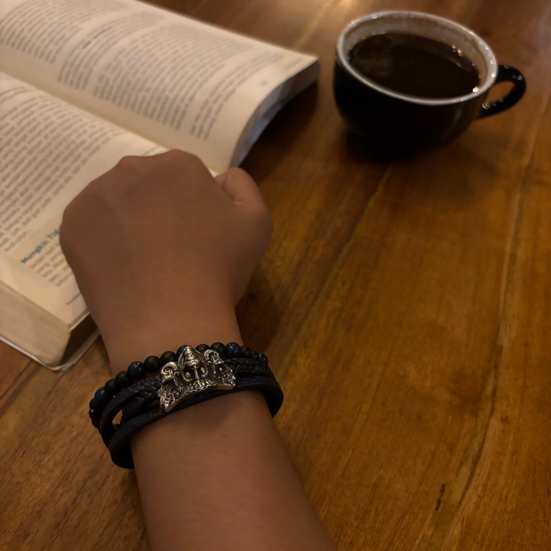 A silver figure bracelet worn during a quiet café moment in Bali