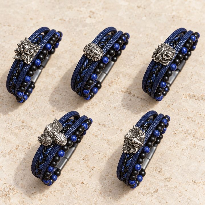 Five silver figure bracelets on a light stone background